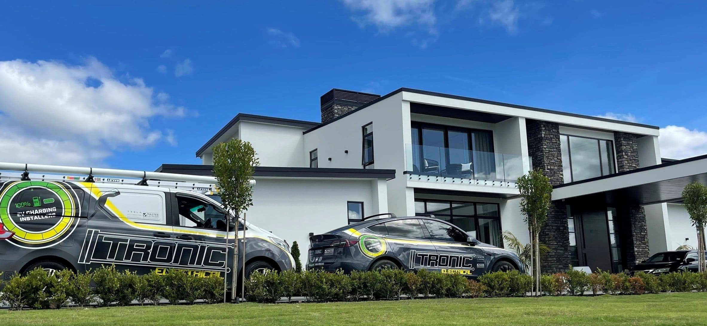 Tronic Electrical van and car outside a modern Auckland home