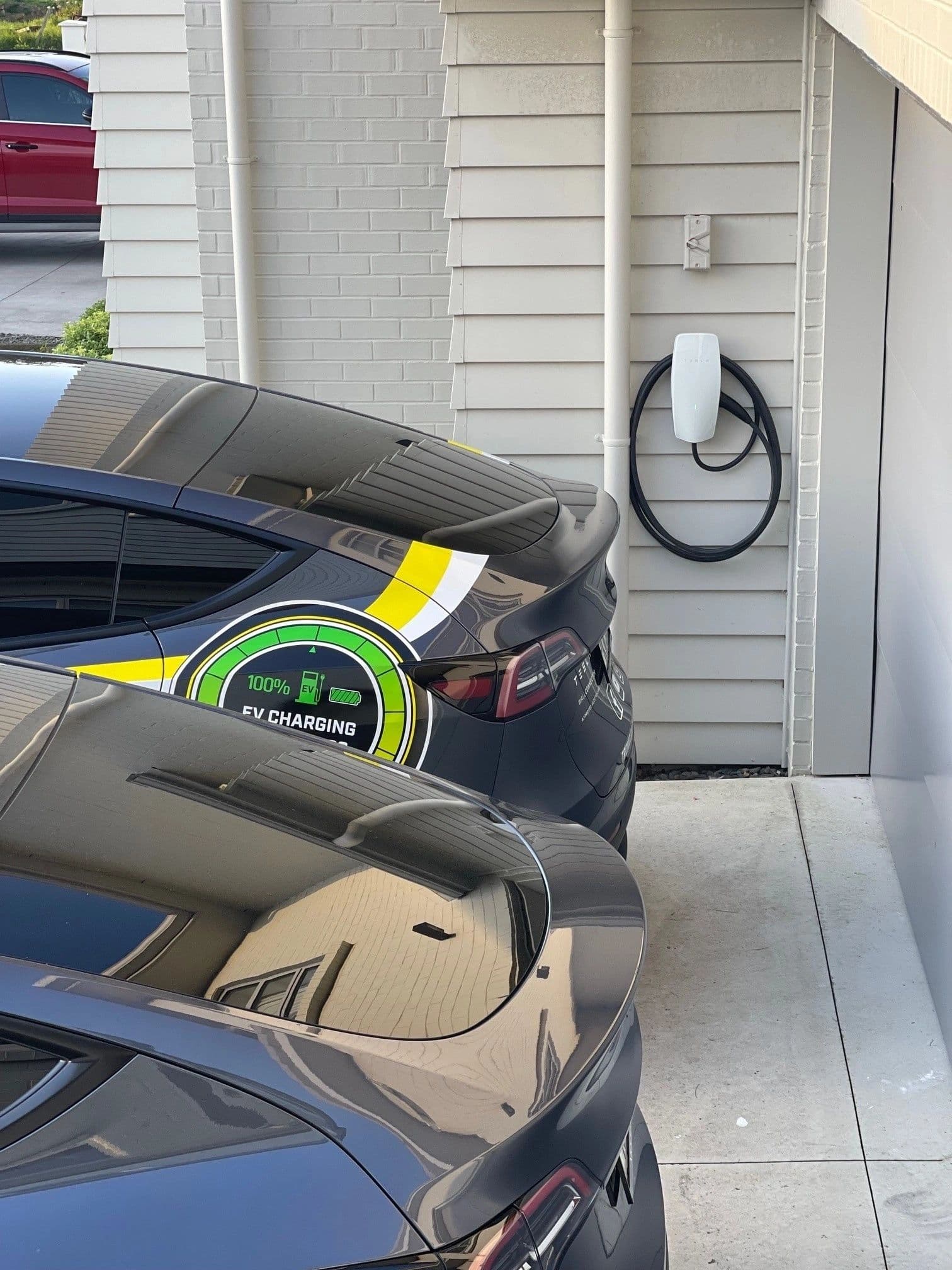 EV charging from a Tronic-installed wall charger on a home driveway