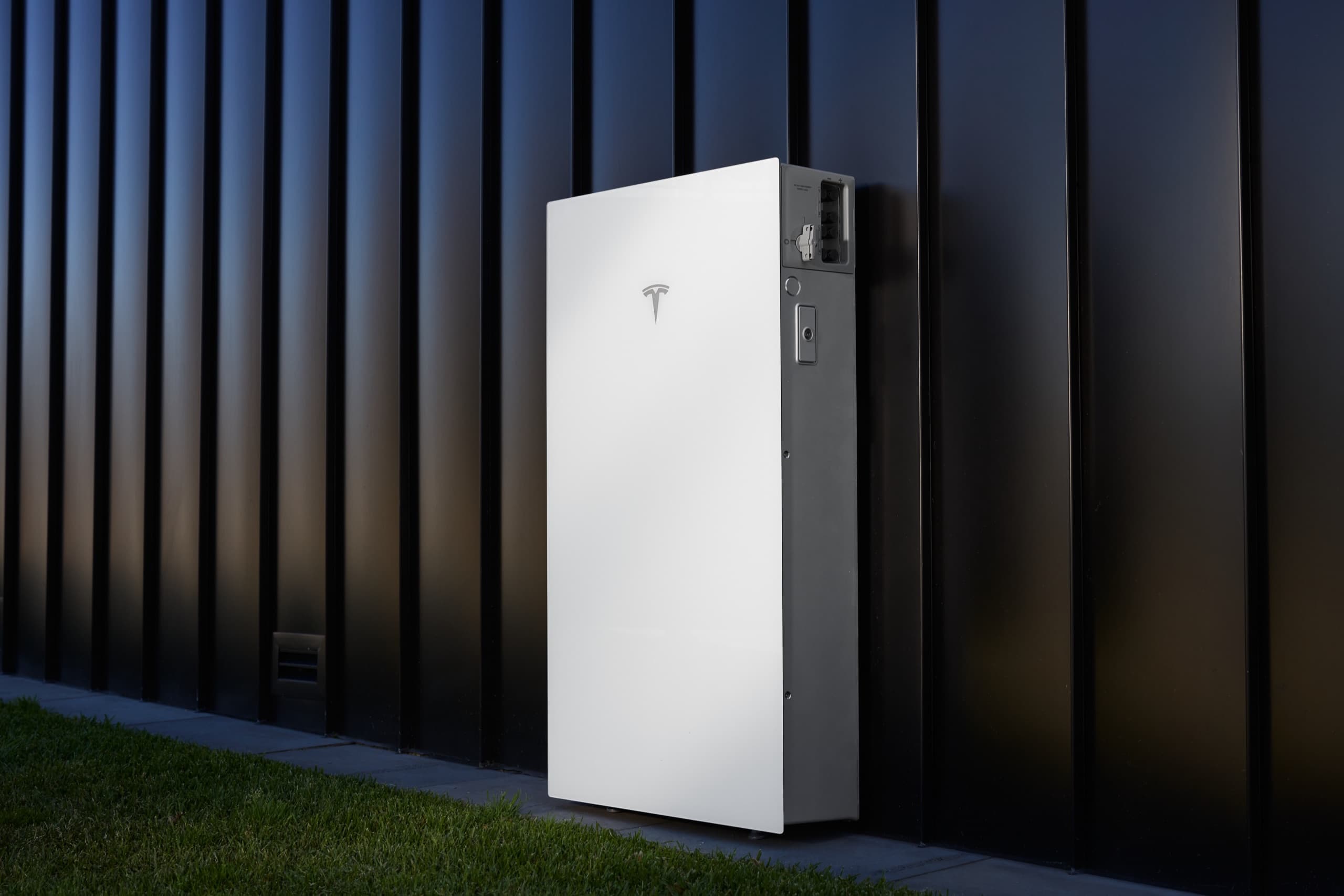 Tesla Powerwall 3P mounted on the exterior wall of a home
