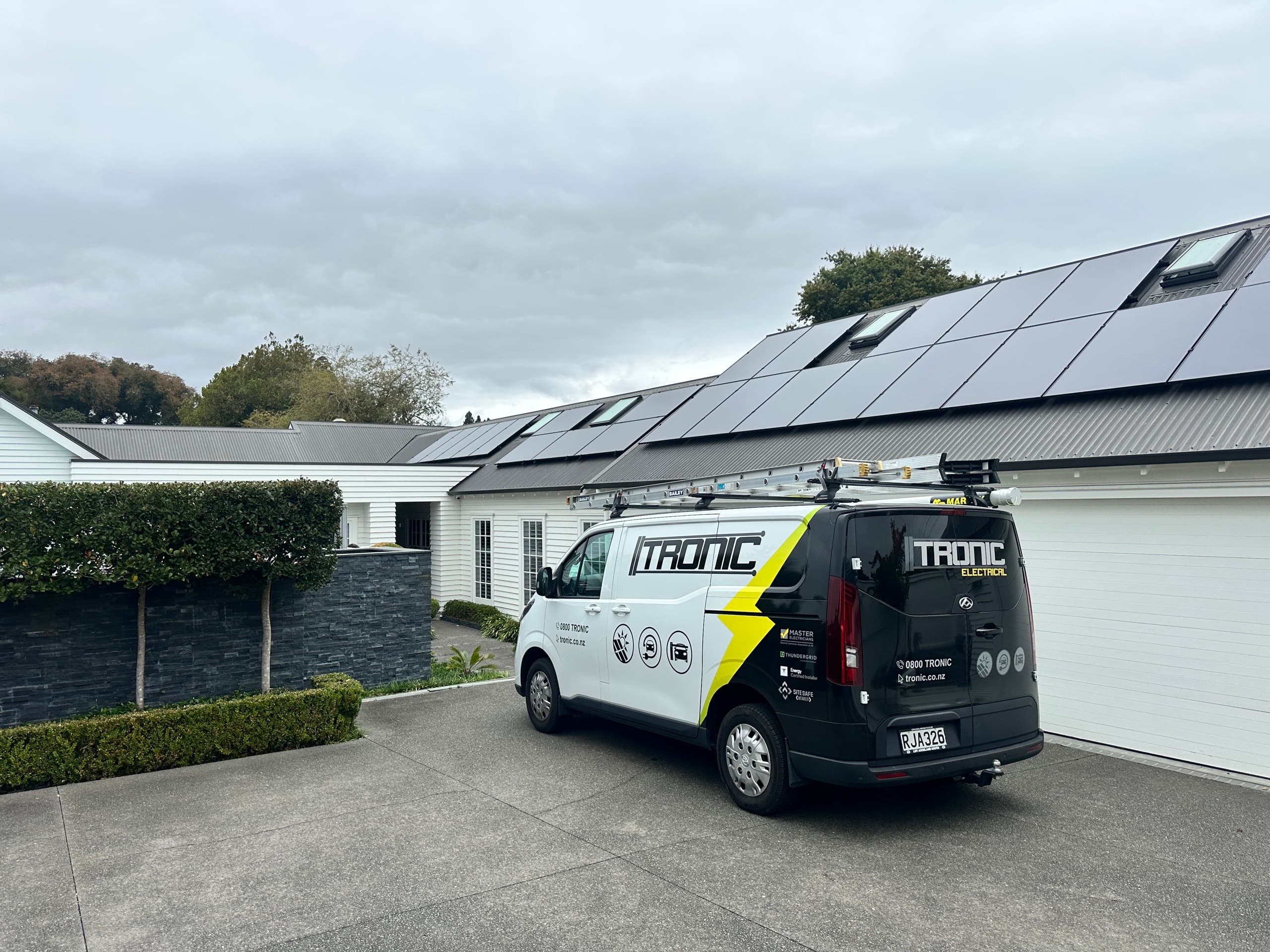 Tronic Electrical van in front of a home with a newly installed solar array